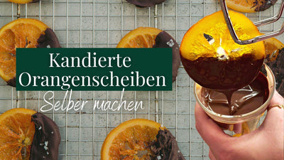 <span>Kandierte Orangenscheiben mit Schokolade überzogen</span><br /><span>🍊🍫</span>